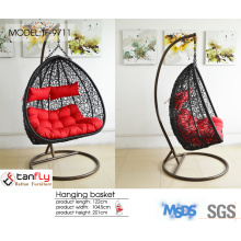Outdoor hanging wicker swing chair for leisure time.